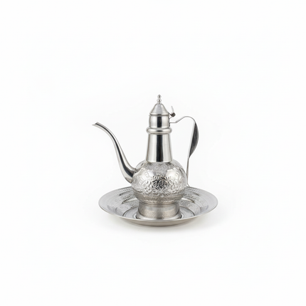 Traditional Arabic coffee pot dallah with ornate engraved design on matching tray