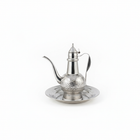 Traditional Arabic coffee pot dallah with ornate engraved design on matching tray