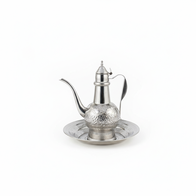 Traditional Arabic coffee pot dallah with ornate engraved design on matching tray