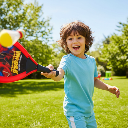 Child playing with Spiderman tennis racket outdoors