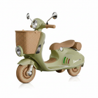 Sage green Vespa electric scooter with wicker basket